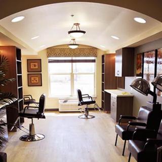 A well-lit hair salon interior with chairs and mirrors.