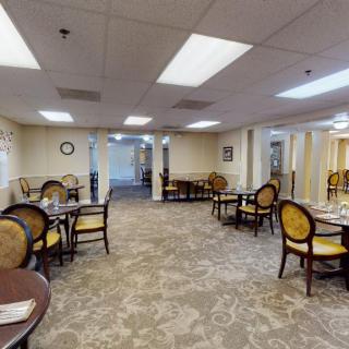 A spacious dining room with elegant seating and well-lit interior.