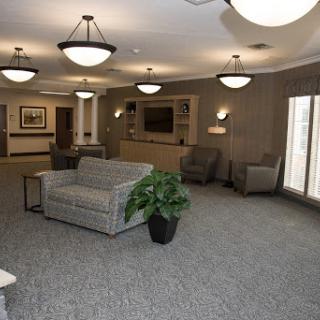 A cozy lounge area featuring comfortable seating and soft lighting.