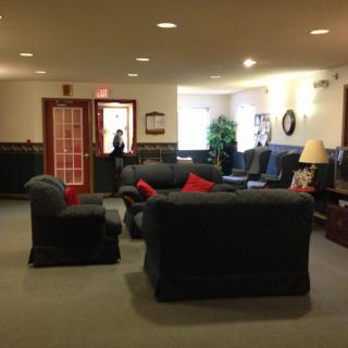 A cozy lobby seating area with sofas and armchairs.