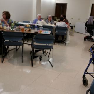 A community gathering for seniors enjoying a meal together.