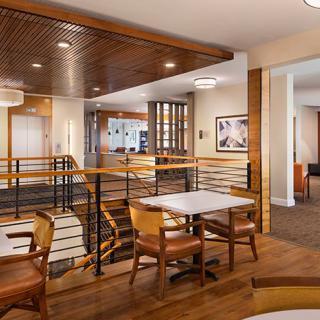 A modern restaurant interior featuring wooden furniture and stylish lighting.