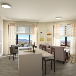 A modern open-concept living and dining area with a kitchen, featuring stylish furniture and large windows offering scenic views.