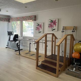 A rehabilitation room equipped with exercise equipment for physical therapy.