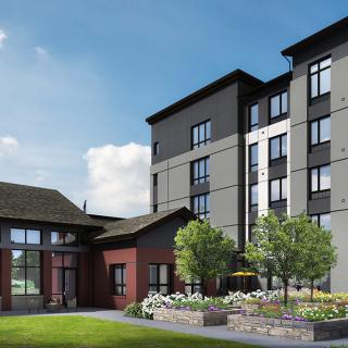 A modern residential building with well-maintained landscaping and outdoor features.