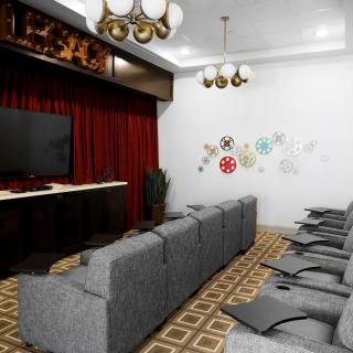 A modern home theater setup with comfortable seating and a large screen.