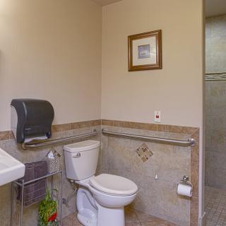 A clean, accessible bathroom with modern fixtures and wall art.