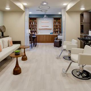 A modern salon with comfortable seating and stylish decor.