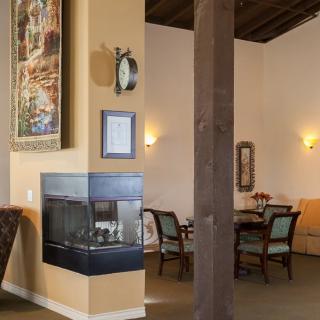 A cozy dining area with a modern fireplace and elegant decor.
