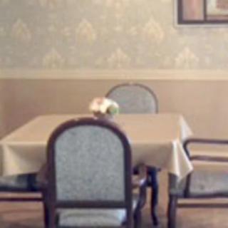 A cozy dining room with a table and four chairs set for a meal.