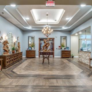 A beautifully decorated lobby featuring elegant furniture, a chandelier, and intricate flooring.