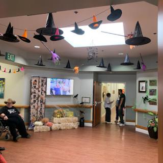 A festive community center decorated with Halloween hats and cheerful ambiance.