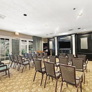 A spacious meeting room equipped with chairs arranged for a presentation.