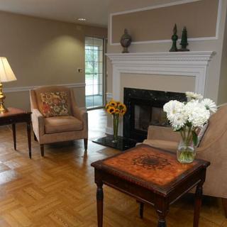 A cozy living room featuring a fireplace, comfortable seating, and elegant dcor.