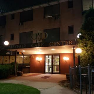 Entrance of a building illuminated at night.