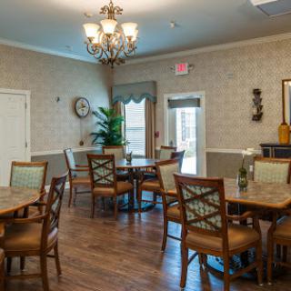 A cozy dining area featuring wooden furniture, a chandelier, and decorative elements.