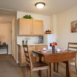 A cozy dining area in a kitchen with wooden furniture and modern decor.