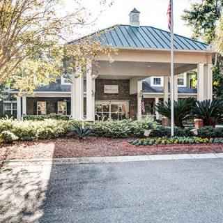 A welcoming building entrance with landscaped surroundings.