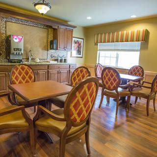 A cozy dining area with wooden furniture and warm lighting.