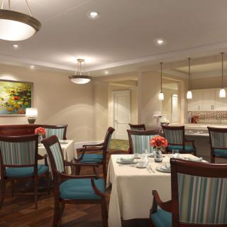 A cozy and elegant dining area with neatly arranged tables and chairs, accented by soft lighting and tasteful decor.