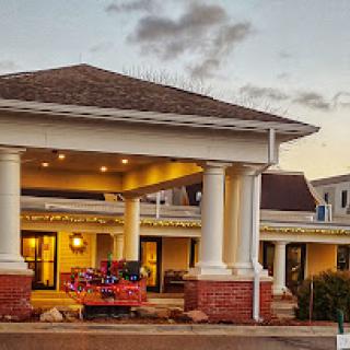 A beautifully designed hotel entrance at sunset, showcasing elegant architecture with columns.