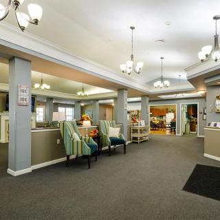 A spacious lobby area with comfortable seating and elegant chandeliers.