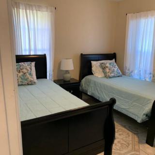 A cozy bedroom with twin beds and light blue bedding.