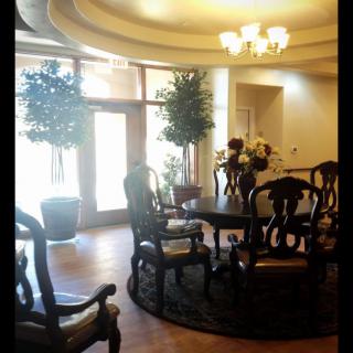 A well-lit lobby with elegant furniture and decorative plants.