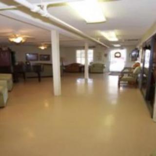 A spacious lobby area with seating and pillars.