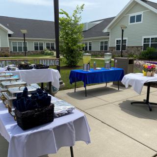 Outdoor buffet setup with tables and catering equipment.