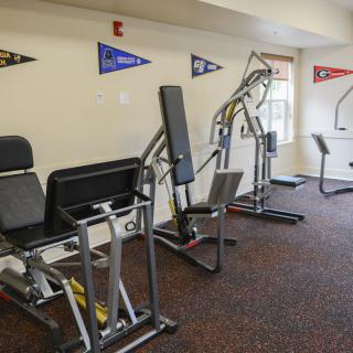 A small fitness room featuring various exercise machines.