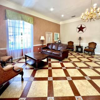 A spacious and elegantly designed living room with a cozy seating arrangement and stylish decor.