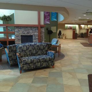 A spacious lobby area with comfortable seating and a fireplace.