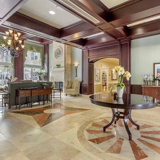 A luxurious hotel lobby featuring elegant decor and a grand chandelier.