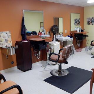 Interior view of a barbershop with chairs and mirrors.