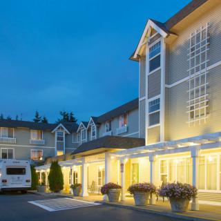 A well-lit hotel building during the evening with a welcoming entrance.