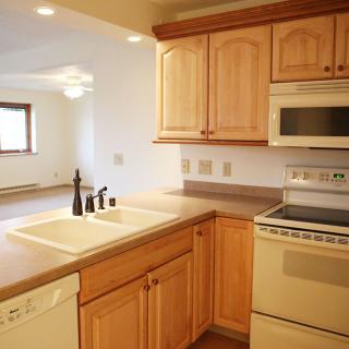 A bright kitchen with wooden cabinets and modern appliances.
