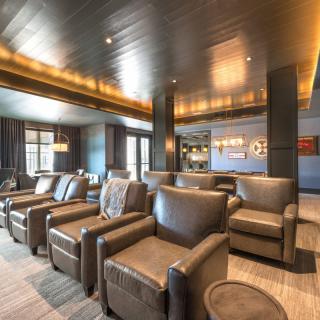 A modern lounge with comfortable seating and elegant lighting.