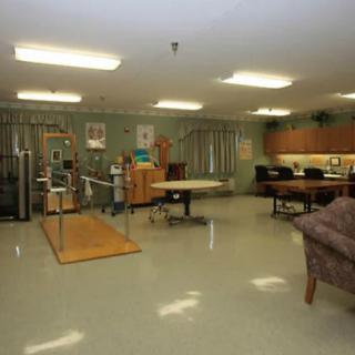 A therapy room equipped with various rehabilitation and exercise equipment.