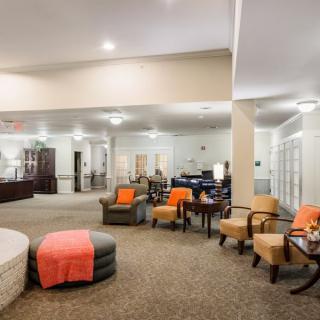 A spacious and cozy lounge area with comfortable seating options, warm lighting, and stylish decor.