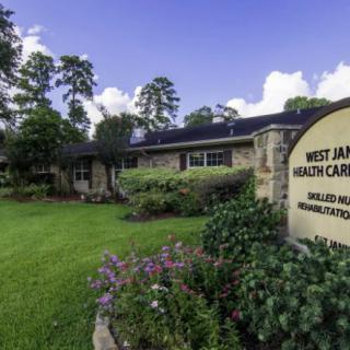 A healthcare clinic with a well-maintained garden and clear signage.
