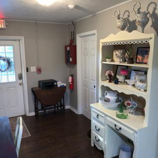 A cozy kitchen interior featuring decorative shelves and a welcoming atmosphere.