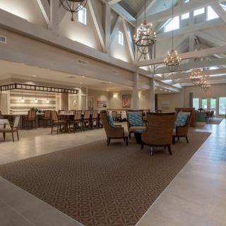 Spacious lobby with elegant chandeliers and comfortable seating.