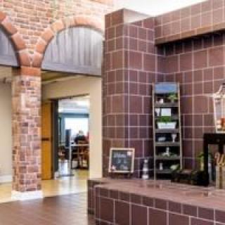A modern office interior with exposed brick walls and stylish shelving.