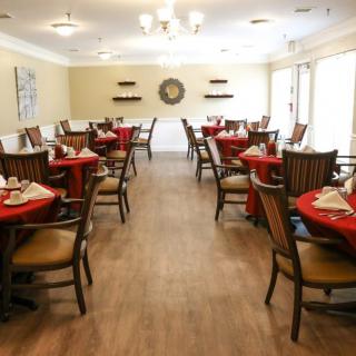 An elegantly decorated dining room with tables set for a meal.