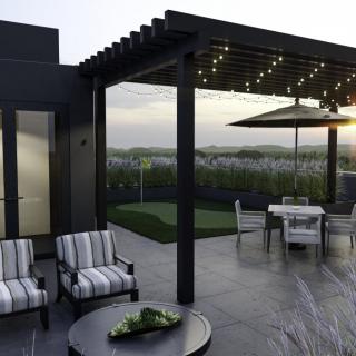 A stylish rooftop terrace with a pergola, featuring outdoor seating and string lights at sunset.