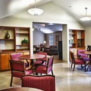 A cozy dining area with round tables, chairs, and ambient lighting.
