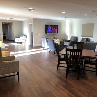 A spacious and well-lit living area with comfortable seating and a television.