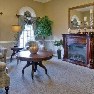 A traditional living room featuring a fireplace, elegant furniture, and stylish decor.