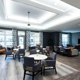 A modern lounge area with stylish furniture and soft lighting.
